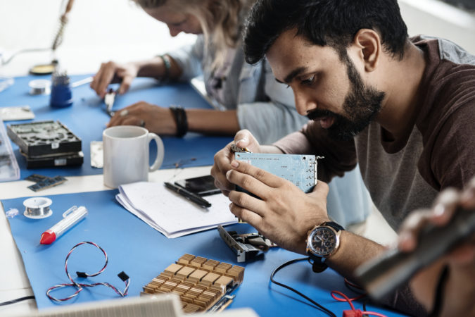 Electrical technicians working on electronics parts